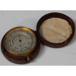 A late 19th/early 20th century gilt brass cased pocket barometer, the silvered dial with mercury