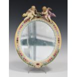 A Meissen porcelain oval mirror frame, late 19th century, moulded with polychrome enamelled oval