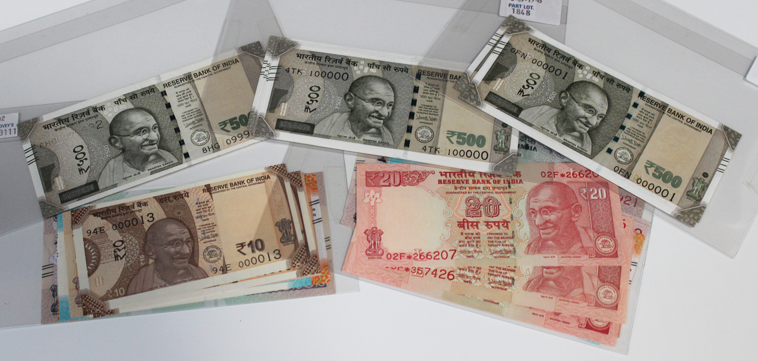 A collection of Indian banknotes, including a five hundred rupees, dated 2017 error, and a