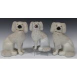 A pair of Staffordshire pottery poodles, late 19th century, with shredded clay fur detail, height