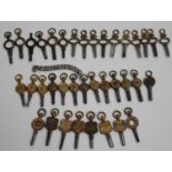 A collection of thirty-seven pocket and fob watch keys, including eight advertising watch keys and