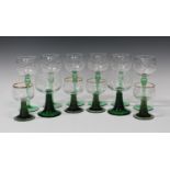 A mixed collection of Continental etched and enamelled green stem glasses, including six hock