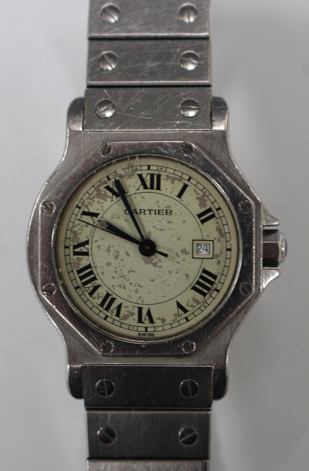 A Cartier steel cased automatic wristwatch, the signed cream coloured dial with date-of-the-month