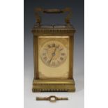 A late 19th/early 20th century lacquered brass carriage clock with eight day movement repeating
