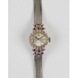 A white gold, diamond and synthetic ruby lady's bracelet wristwatch, the silvered dial with baton