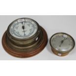 An early 20th century brass cased circular wall barometer, the dial detailed 'John Barker & Co Ltd