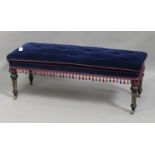 A late Victorian Aesthetic period ebonized and parcel gilt rectangular stool, upholstered in blue