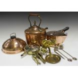 A small group of metalwork, including a copper hot water bottle, a copper pan with pouring lip, a