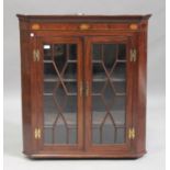 A George III mahogany hanging corner display cabinet with inlaid conch shell and fan paterae, fitted