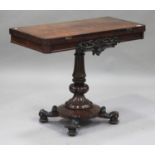 An early Victorian rosewood fold-over card table, raised on a turned and carved baluster column, the