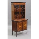 An Edwardian Neoclassical Revival mahogany and inlaid bookcase cabinet, the dentil moulded