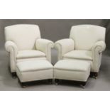 A pair of George V Howard style scroll armchairs, upholstered in cream fabric, raised on turned feet