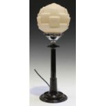 An Art Deco brown Bakelite and chromium plated table lamp with a tinted opaline glass shade, the
