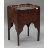 A 19th century mahogany night table with a pierced gallery top, the fall front raised on block legs,