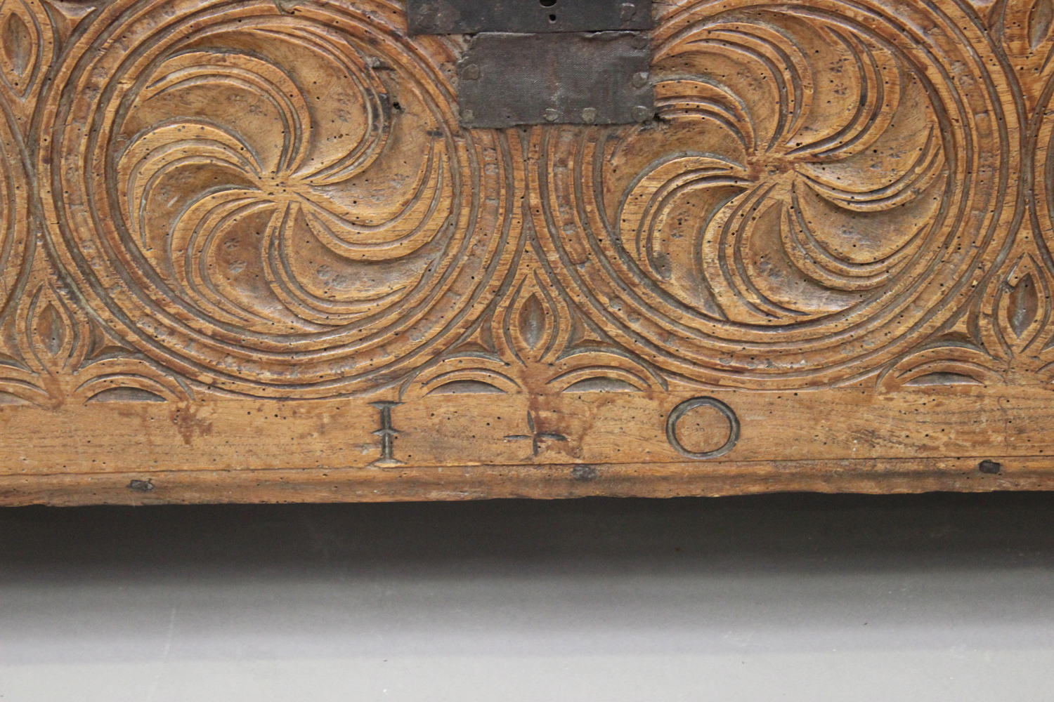 A 17th century elm six plank coffer, the hinged lid above a carved panel front, on shaped ends, - Image 2 of 2