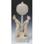 An early 20th century carved white marble and alabaster figural table lamp, the circular shade and