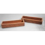 A pair of late 19th/early 20th century terracotta window box planters of rectangular form, three