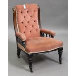 A Victorian oak framed salon armchair, upholstered in pink velour, on turned and fluted legs, height