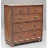 A late Victorian pitch pine chest of two short and three long drawers, on a plinth base and castors,