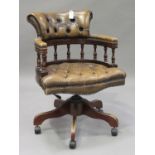 A 20th century reproduction buttoned brown leather tub back office chair, on downswept legs and