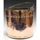 A 19th century copper cylindrical log bucket of studded construction with applied brass swing
