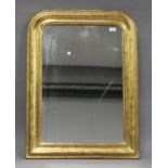 A 19th century gilded arch framed wall mirror with incised leaf and flower decoration, 94cm x 68cm.