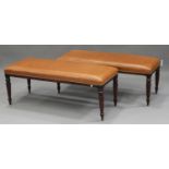 A pair of late 20th century Regency style mahogany footstools with overstuffed brown leather