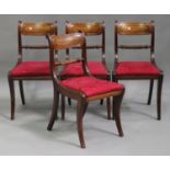 A set of four Regency mahogany bar back dining chairs, the drop-in seats raised on sabre legs,
