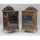 A pair of early 20th century French mahogany and gilt metal mounted music cabinets, each