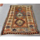 A Bordjalou Kazak rug, West Caucasus, early 20th century, the shaded terracotta field with three
