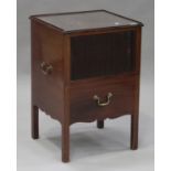 A George III mahogany bedside cabinet, fitted with brass carrying handles, the tambour front above a