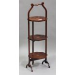 An Edwardian mahogany three-tier folding cake stand with transfer printed fan paterae, height