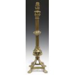 A Victorian Gothic Revival gilt brass candlestick, converted to electricity, the cluster column stem