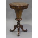 A Victorian burr walnut circular work table, the hinged top revealing a compartmentalized