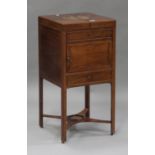 A George III mahogany gentleman's washstand, the double hinged top above a cupboard and a drawer,