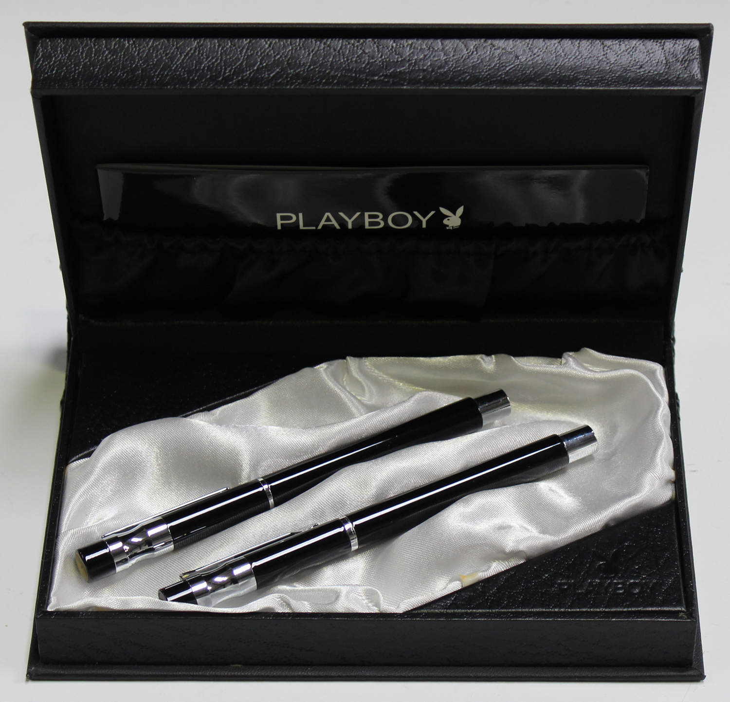 A Playboy fountain pen and rollerball pen set, within a Playboy writing instrument case and box.