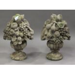 A pair of French cast composition stone garden ornaments, modelled in the form of fruit-laden