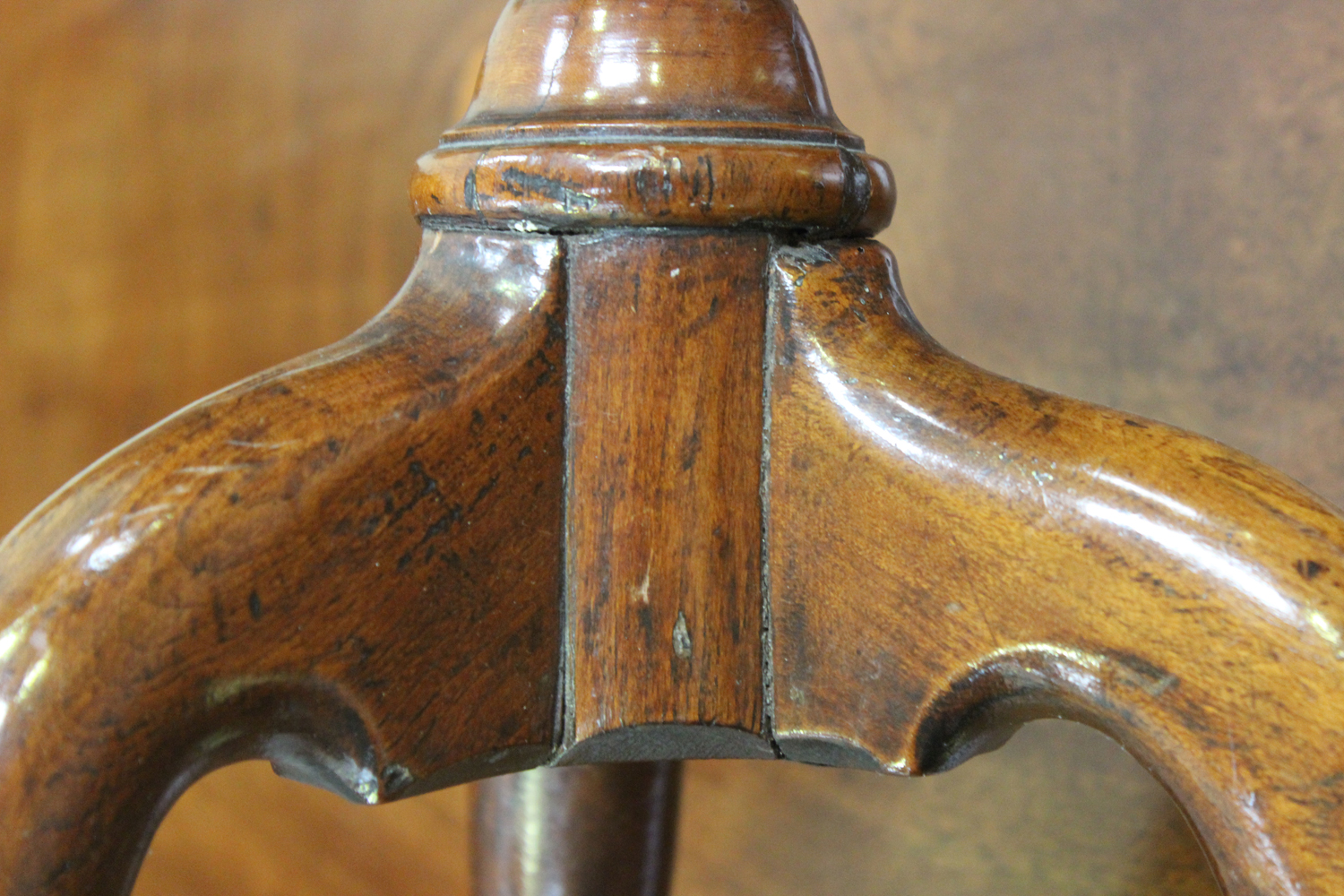 A George I and later mahogany and walnut circular wine table, on a turned baluster stem and tripod - Image 3 of 3