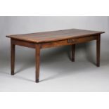 A 19th century fruitwood farmhouse table, the rectangular top above a central frieze drawer,