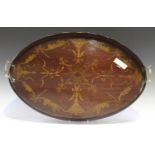 An Edwardian mahogany and foliate inlaid oval tea tray with a raised gallery and gilt brass handles,