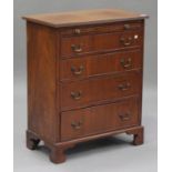 An early/mid-20th century mahogany chest, fitted with a brushing slide above four drawers, on