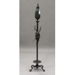 A 19th century green patinated cast bronze Estruscan style standard lamp, the urn-shaped top above a