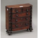 A Regency mahogany diminutive table-top chest of two short and three long drawers, on turned feet,