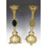 A pair of late 19th/early 20th century Gothic Revival ecclesiastical brass candlesticks, the