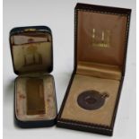 A Dunhill gilt metal pocket lighter, cased, and a Dunhill cigar cutter, cased.Buyer’s Premium 29.