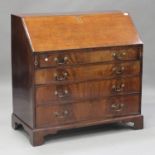 A George III mahogany bureau, the fall front revealing an inlaid interior above four graduated