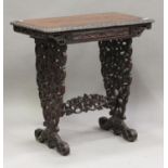 A 19th century Anglo-Indian rosewood work table, profusely carved with leaves and flowers, fitted