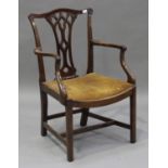 A George III mahogany elbow chair, the pierced splat back above a drop-in seat, raised on block legs