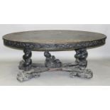 A late Victorian Renaissance Revival stained and carved walnut oval centre table, the top incised