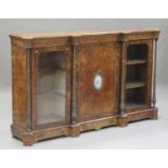 A mid-Victorian burr walnut credenza with gilt metal mounts, the breakfront top above a central door